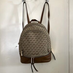 Brown and Beige Micheal Kors Backpack with Gold accents.
